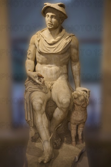 Ancient marble sculpture of a seated man next to a ram, Hermes, seated, on display in the museum, Archaeological Museum, Kos Town, Kos, Dodecanese, Greek Islands, Greece