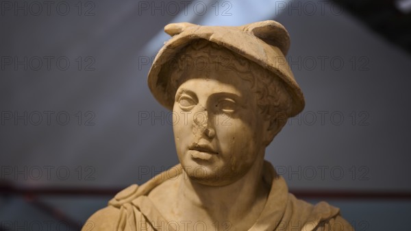 Ancient marble bust of a man wearing a Roman hat, on display in the museum, Hermes, Archaeological Museum, Kos Town, Kos, Dodecanese, Greek Islands, Greece