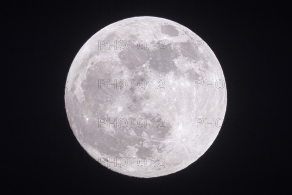 Full moon shining bright in the night sky, shining silver in a clear dark winter night, detailed view of the supermoon over North Rhine-Westphalia Germany, Europe Full moon, fullmoon is shining bright, silver light, close, clear dark winter night, looks close, supermoon, detailed view, January, 2019