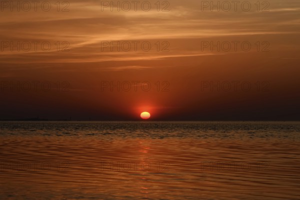 Fireball... Cuxhaven (North Sea), glowing red, setting sun, sunset over the Wadden Sea near Duhnen, sun sinks into the sea, a beautiful day comes to an end, North Sea coast, Germany, Europe, local nature, landscape