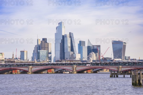 Skyscrapers and a bridge along a river, clear urban skyline, London, United Kingdom, World