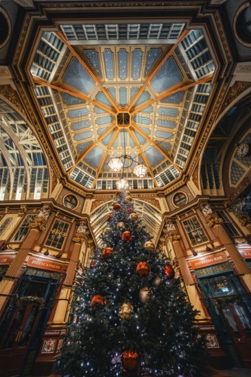 Festive Christmas decoration with large tree under impressive ceiling in an interior, London, United Kingdom, World