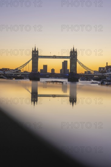Famous bridge at sunset with reflection in the river and skyline in the background, London, United Kingdom, World