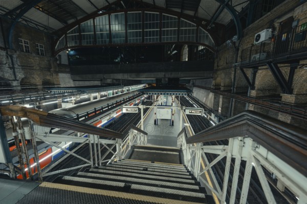 View of empty platform with trains and industrial architecture of a train station, London, United Kingdom, World