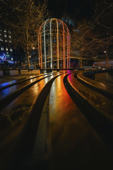 Night scene with colorful illuminated pavilion and twinkling lights in an urban setting, London, United Kingdom, World