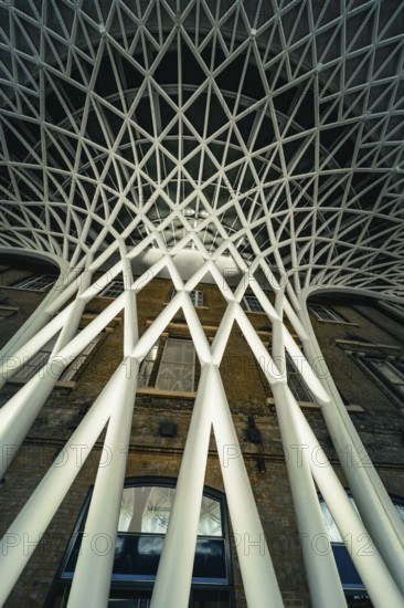 Futuristic geometric ceiling pattern with white pillars in modern architecture, King's Cross Station, London, United Kingdom, World