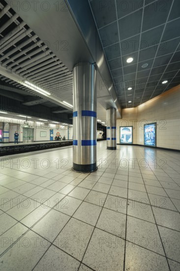 Lonely subway station with tiled floors and modern columns in a cool atmosphere, London, United Kingdom, World