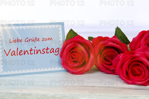 (photo montage) greeting card with the inscription GREETINGS FOR VALENTINE'S DAY next to red roses