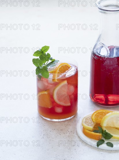 Refreshing pink drink with citrus slices and ice, ready for summer