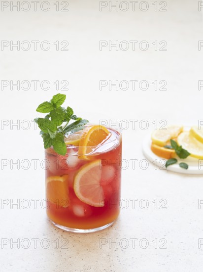 Cold fruit punch with orange, lemon, and mint garnish