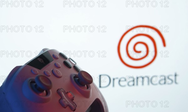 Dhaka, Bangladesh- 24 Mar 2025: A close-up of a gamepad with the Dreamcast seen on screen in the background