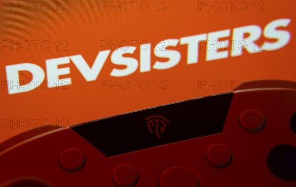 Dhaka, Bangladesh- 24 Mar 2025: A close-up of a gamepad with the Devsisters seen on screen in the background
