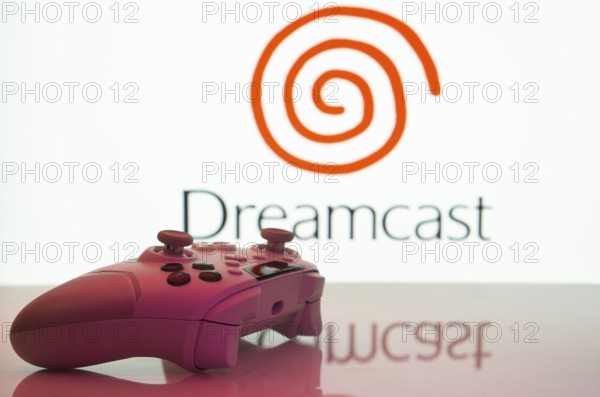Dhaka, Bangladesh- 20 Mar 2025: A close-up of a white gamepad with the Dreamcast seen on screen in the background