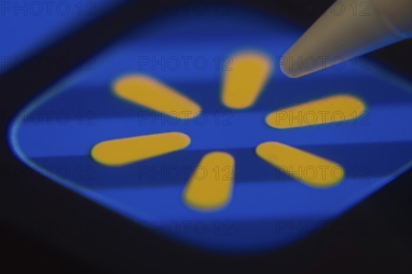 Dhaka, Bangladesh- 06 Dec 2025: Close-up of the Walmart app on a screen with a stylus pointing at it