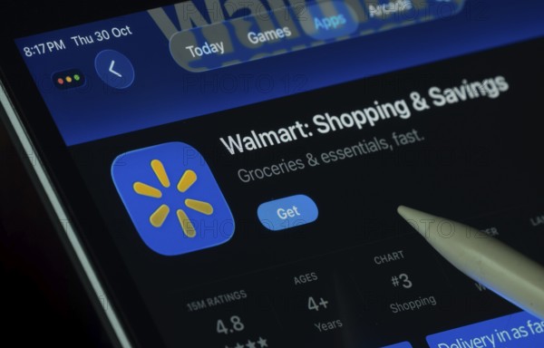 Dhaka, Bangladesh- 30 Oct 2025: Walmart app displayed on a iPad screen in dark mode with a digital pen pointing at it