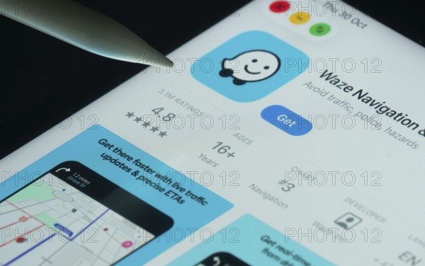 Dhaka, Bangladesh- 30 Oct 2025: Waze app on a iPad screen with a pen pointing at the install option