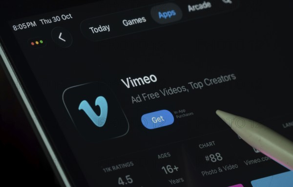 Dhaka, Bangladesh- 30 Oct 2025: Vimeo app displayed on a iPad screen in dark mode with a digital pen pointing at it