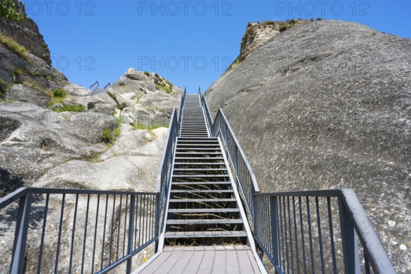 Rocky landscape with stairs and bright blue sky, Uplistsikhe cave town, Uplistsikhe, Inner Kartli region, Shida Kartli, Georgia