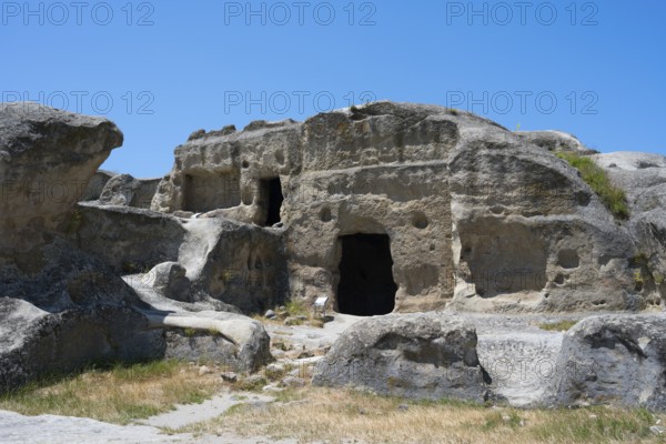 Ancient rock structure with several cave entrances in natural surroundings, Uplistsikhe cave town, Uplistsikhe, Inner Kartli region, Shida Kartli, Georgia