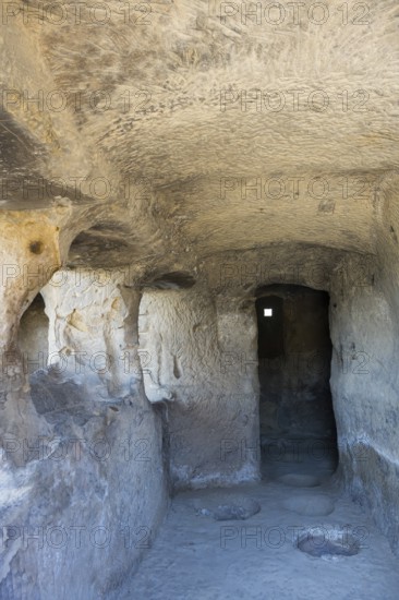 Narrow cave passage with stone walls and a small window, ancient atmosphere, cave town Uplistsikhe, Inner Kartli region, Shida Kartli, Georgia