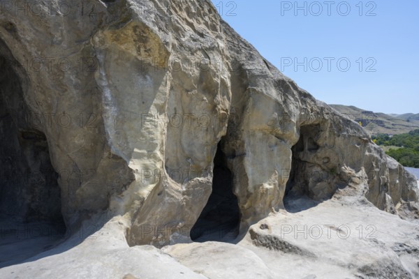 Naturally-designed cave exterior with visible rock structure in front of the open sky, cave town Uplistsikhe, Inner Kartli region, Shida Kartli, Georgia