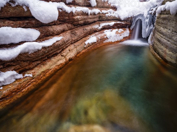 Taugl or Tauglbach flows through the snow-covered and icy red gorge, also Marmorklamm, Bad Vigaun, Tennengau, Salzburg, Austria