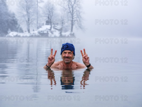 Man, 55, with Victory sign, ice bathing, also winter bathing in Königssee, Schönau am Königssee, Berchtesgadener Land, Upper Bavaria, Bavaria, Germany