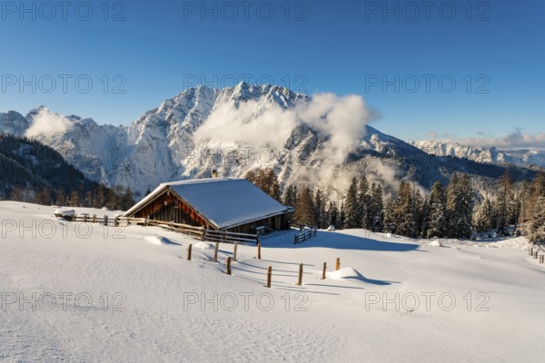 Deep snow-covered Priesbergalm, Watzmann with clouds behind, Berchtesgaden Alps, Berchtesgaden National Park, Schönau am Königssee, Berchtesgadener Land, Upper Bavaria, Bavaria, Germany
