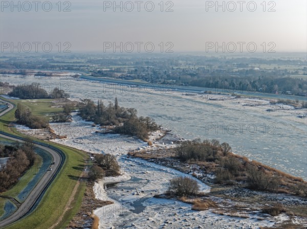 Ice rink on the Elbe near Hamburg. The foothills of the Elbe are icy in the flooded area. On the left, take the Elbufer-Straße Kraueler Hauptdeich. Kirchwerder, Hamburg, Germany