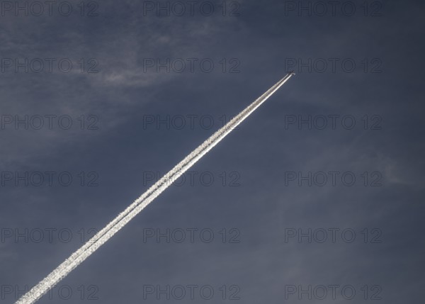 Contrails and passenger jets high in the sky