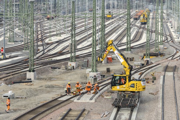 Large-scale track system with construction by several workers and a crane truck, Untertürkheim parking station, Stuttgart, Baden-Württemberg, Germany