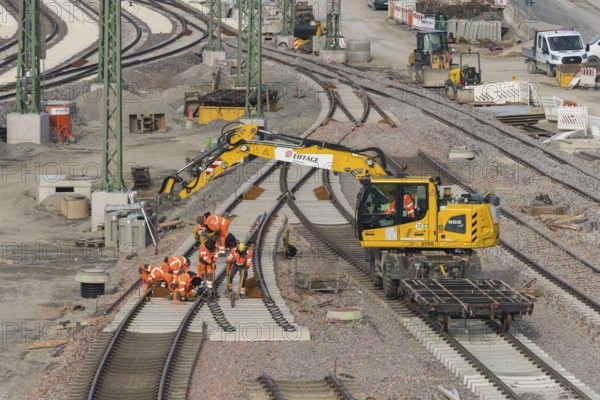 Workers and excavators renovating railroad tracks on a municipal construction site, Untertürkheim parking lot, Stuttgart, Baden-Württemberg, Germany