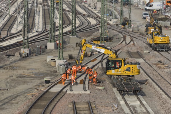 Workers wearing orange safety clothing work on railroad tracks with technical equipment, Untertürkheim parking station, Stuttgart, Baden-Württemberg, Germany