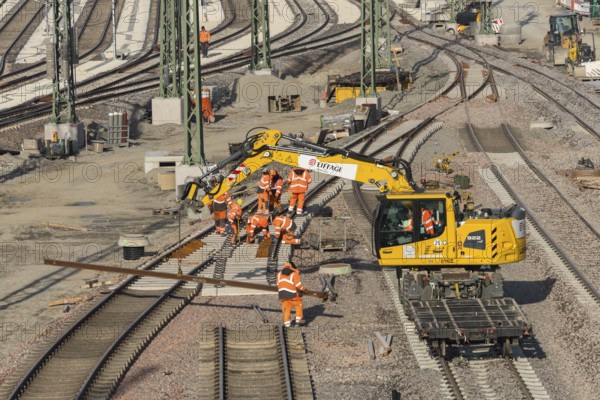 Workers wearing protective clothing carry out construction work on a railway construction site, Untertürkheim parking lot, Stuttgart, Baden-Württemberg, Germany