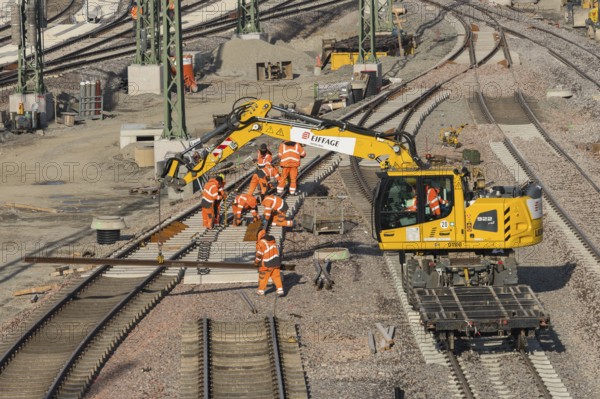 Track construction in progress using a large yellow construction machinery vehicle, Untertürkheim parking station, Stuttgart, Baden-Württemberg, Germany