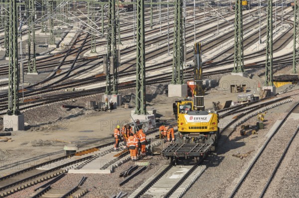 Team of workers works on rails using construction machinery at a large plant, Untertürkheim parking station, Stuttgart, Baden-Württemberg, Germany