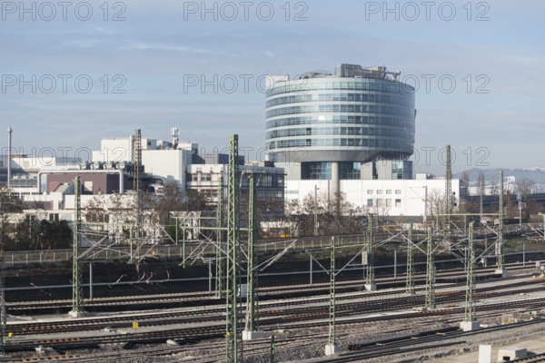 Modern building in an industrial area with railroad tracks in the foreground under clear skies, view of Daimler headquarters, Untertürkheim plant, Stuttgart, Baden-Württemberg, Germany
