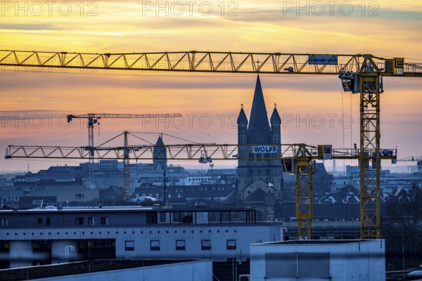 View of downtown Cologne, construction cranes from various construction sites, tower of Groß St. Martin church, North Rhine-Westphalia, Germany