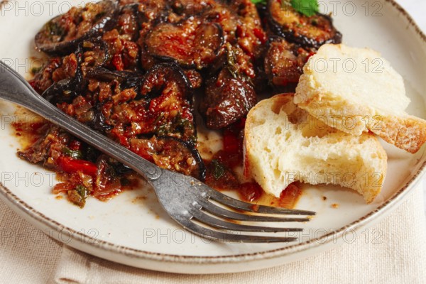 Stewed meat with eggplant is a Georgian dish, on a light background, homemade, no people