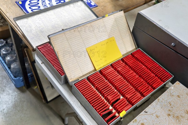 Metal slide storage boxes with vintage 35mm film transparency slides at auction, UK