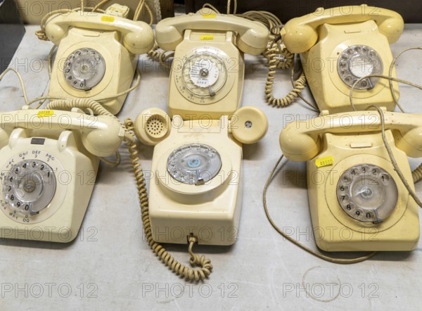 Vintage analogue dial landline telephones on display at auction, UK
