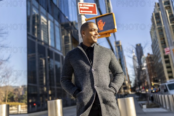 Mixed-race businessman smiling, enjoying a casual walk through the busy streets of manhattan, new york city, reflecting success and modern urban lifestyle, with tall buildings in the background