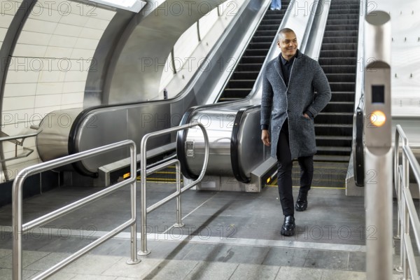 Professional man commuting through a modern subway station, coming down an escalator with a confident and focused expression, reflecting urban lifestyle and daily transit