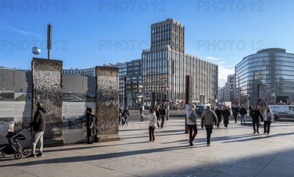 Wall segment, tourists and passers-by at Potsdamer Platz, Berlin, Germany