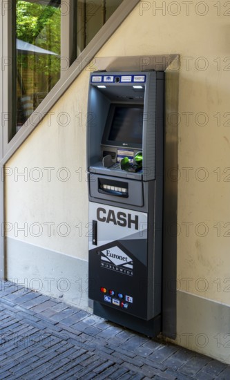 Euronet cash machine at the gateway to a backyard, Potsdam, Brandenburg, Germany