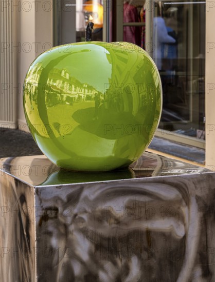 Design of a green apple in front of a shop in downtown Potsdam, Brandenburg, Germany