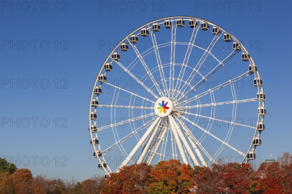 The Montreal Observation Ferris Wheel or La Grande Roue de Montreal amusement ride in autumn, Old Port of Montreal, Quebec, Canada. George Ferris (1859–96), is the American engineer who invented the ferris wheel