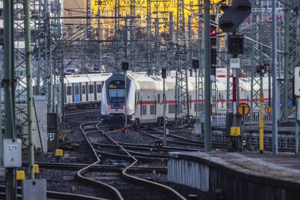 InterCity IC to Zurich leaving Stuttgart Central Station in the morning. Rail signals and overhead lines in early morning light. Stuttgart, Baden-Württemberg, Germany