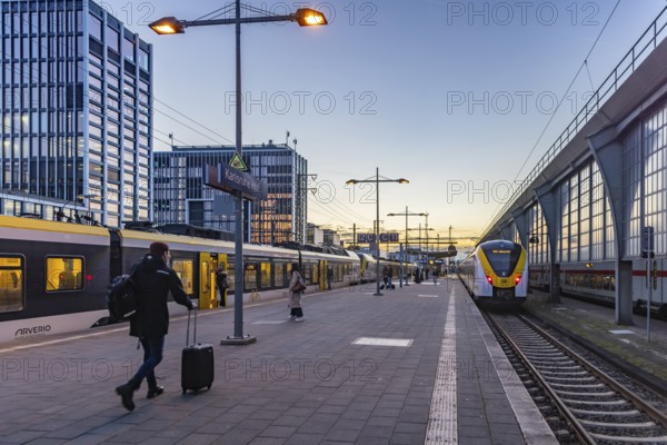 Regional train from Arverio at Karlsruhe main station in the evening. Platform with passengers. Karlsruhe, Baden-Württemberg, Germany