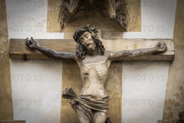 Christ sculpture from the former monastery church of S. Johannes Baptistam above portal of the monastery church, Blaubeuren Abbey, Swabian Jura, Baden-Württemberg, Germany
